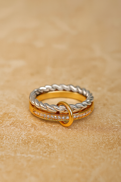 Flat lay of Livia two-tone double-band ring with silver rope band and gold pavé bar