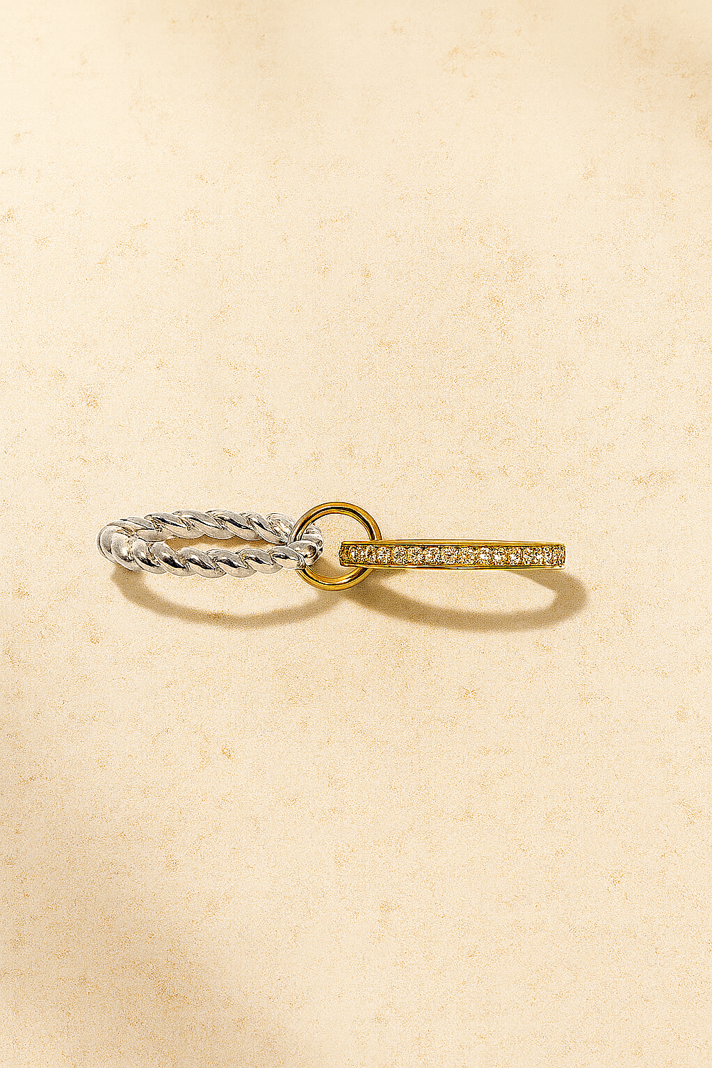 Mixed ring stack on hand featuring two-tone Livia ring with silver and gold bands.