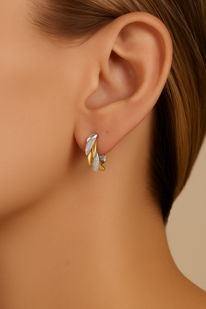 Model wearing Elara Two-Tone Huggie Earring — sculptural gold and silver hoop with pavé sparkle by Galleria Armadoro.
