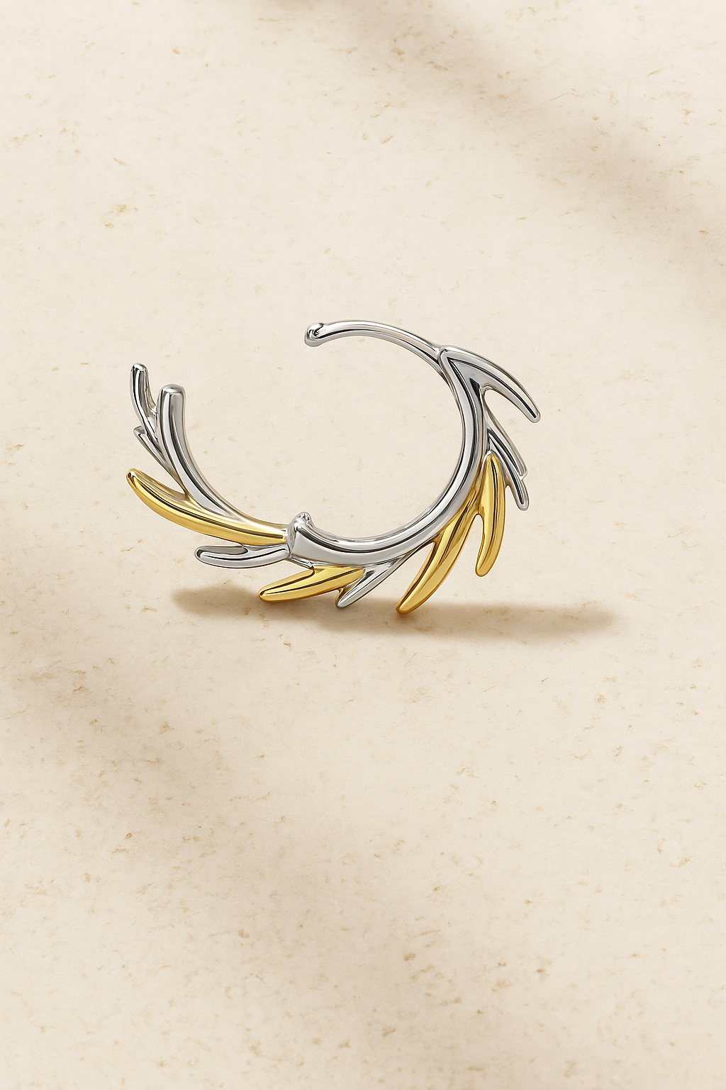 Open view of Elara Two-Tone Huggie Earring showing fluid sculptural form in gold and silver plating with CZ pavé details.
