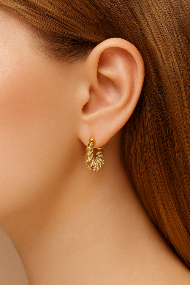 Model wearing Marielle Gold Huggie Earring — sculptural ribbon-inspired hoop plated in 18ct gold with pavé CZ stones by Galleria Armadoro.
