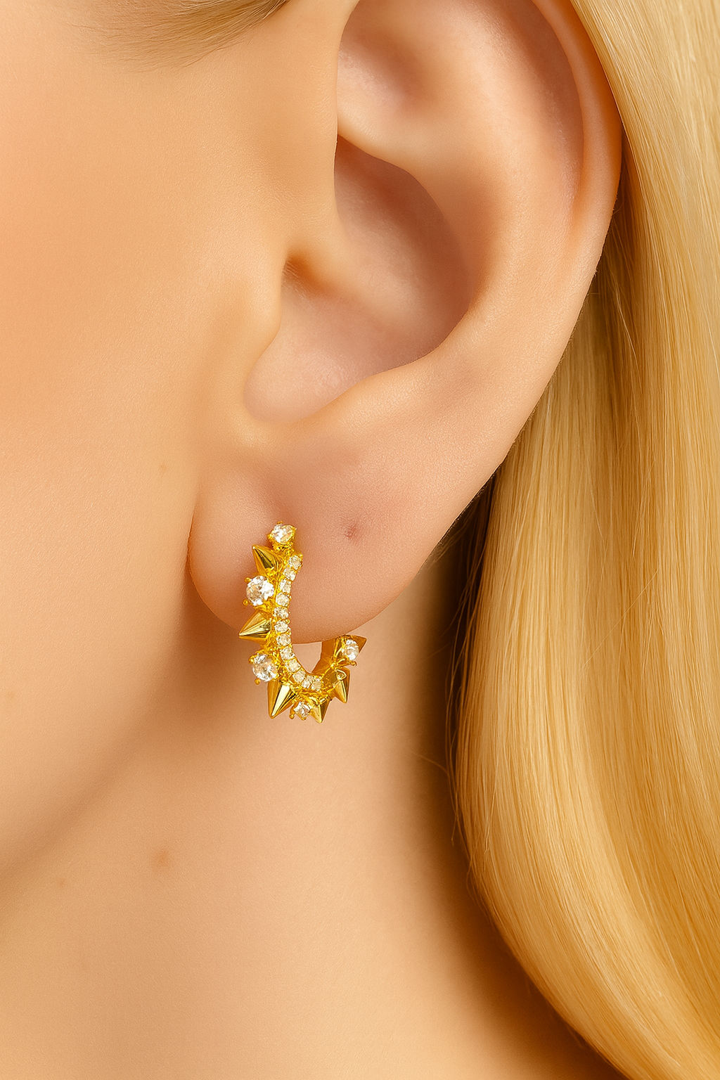 Model wearing Spina Gold Huggie Earring — 18ct gold-plated spiked hoop with pavé cubic zirconia by Galleria Armadoro.
