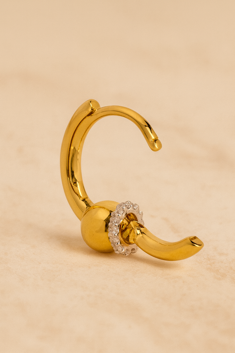 Open gold Kora bead huggie showing hinged design and crystal halo