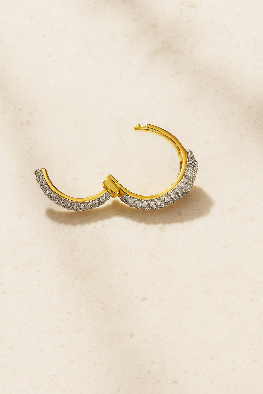 Open view of Ophelia pavé huggie showing hinge mechanism and micro-pavé stones.