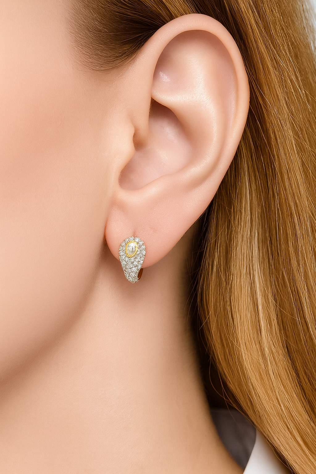 Ophelia pavé huggie worn on earlobe, pear-shaped centre stone facing forward.