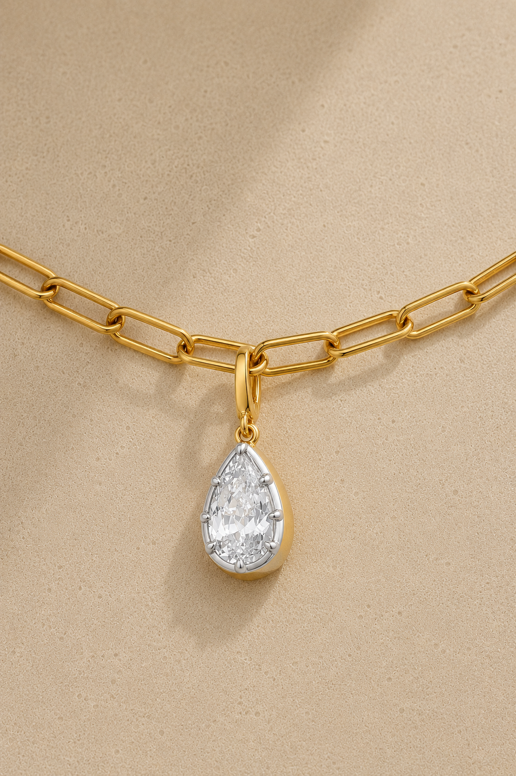 Close-up of silver and gold Vittoria crystal charm attached to gold paperclip chain