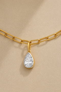 Close-up of silver and gold Vittoria crystal charm attached to gold paperclip chain