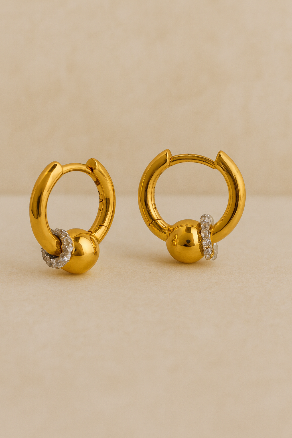 Pair of Kora gold bead huggie earrings with halo-set crystals