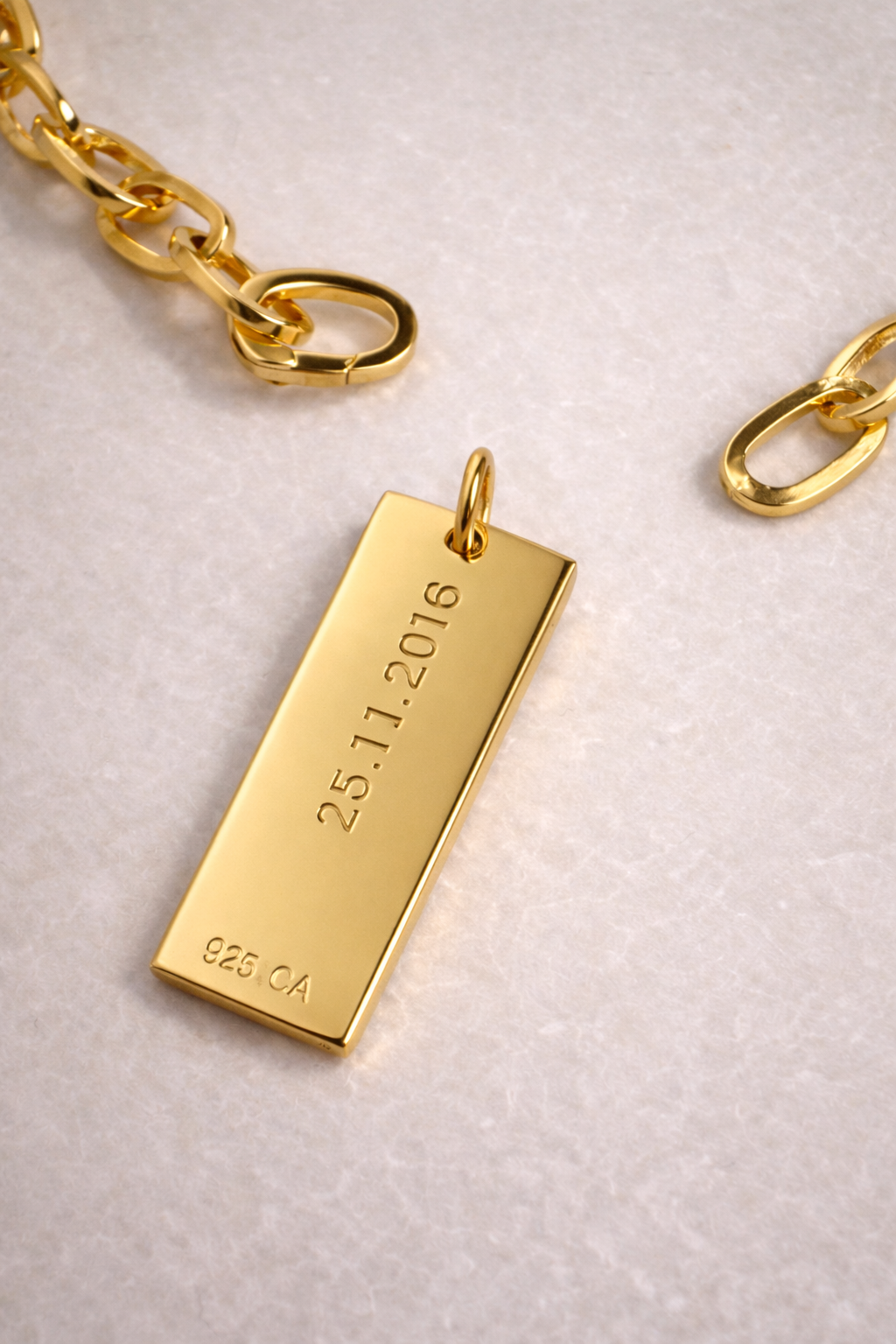 Personalised gold dog tag necklace charm, minimalist rectangular pendant close-up