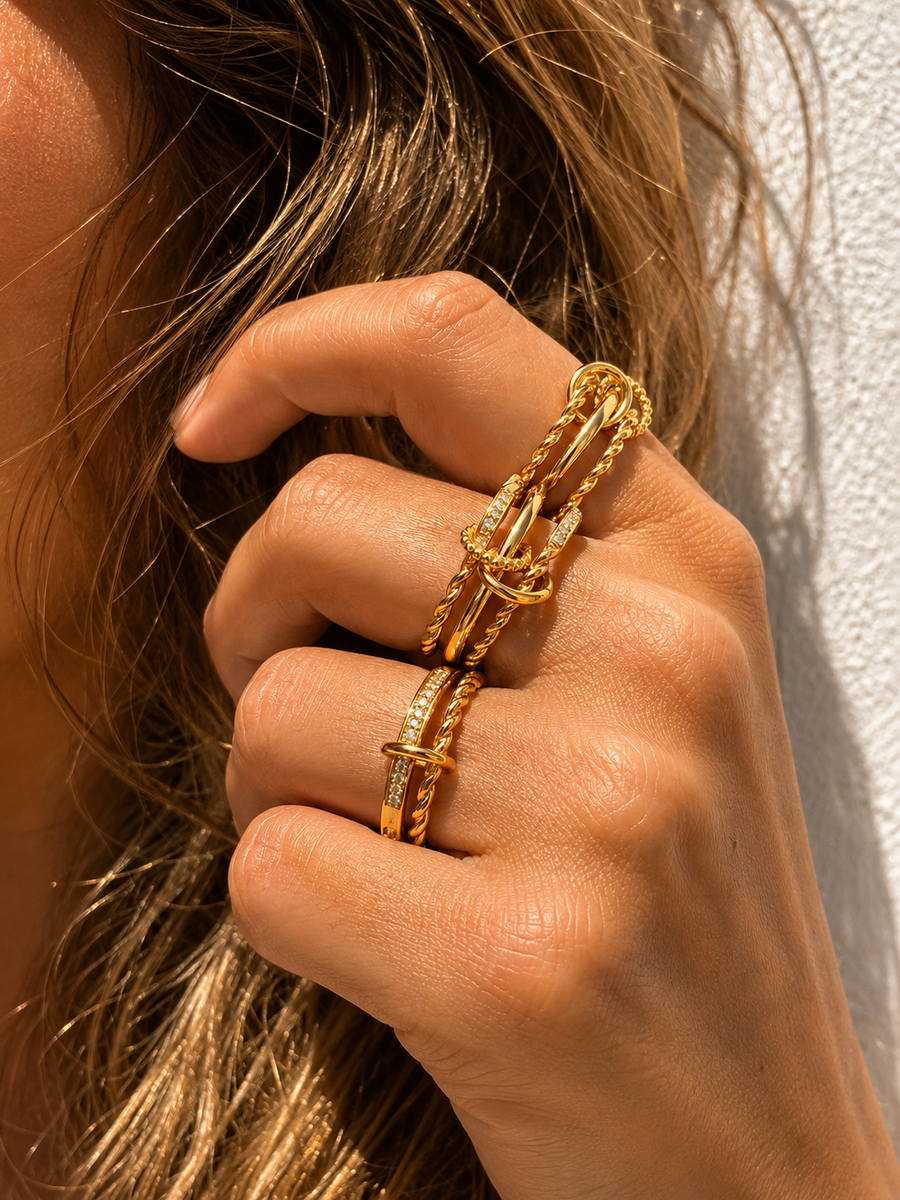Gold ring stack styled by Galleria Armadoro with sculptural rope rings, polished gold bands and pavé details.