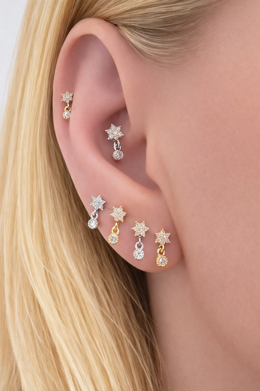 Ear piercing stack styling with Romy stud in gold, second lobe piercing and multiple earring placement ideas