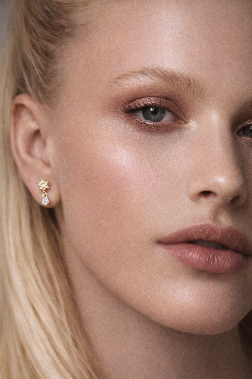 Close-up model wearing Romy gold stud earring in curated ear, classy cute ear piercings and top jewellery trends