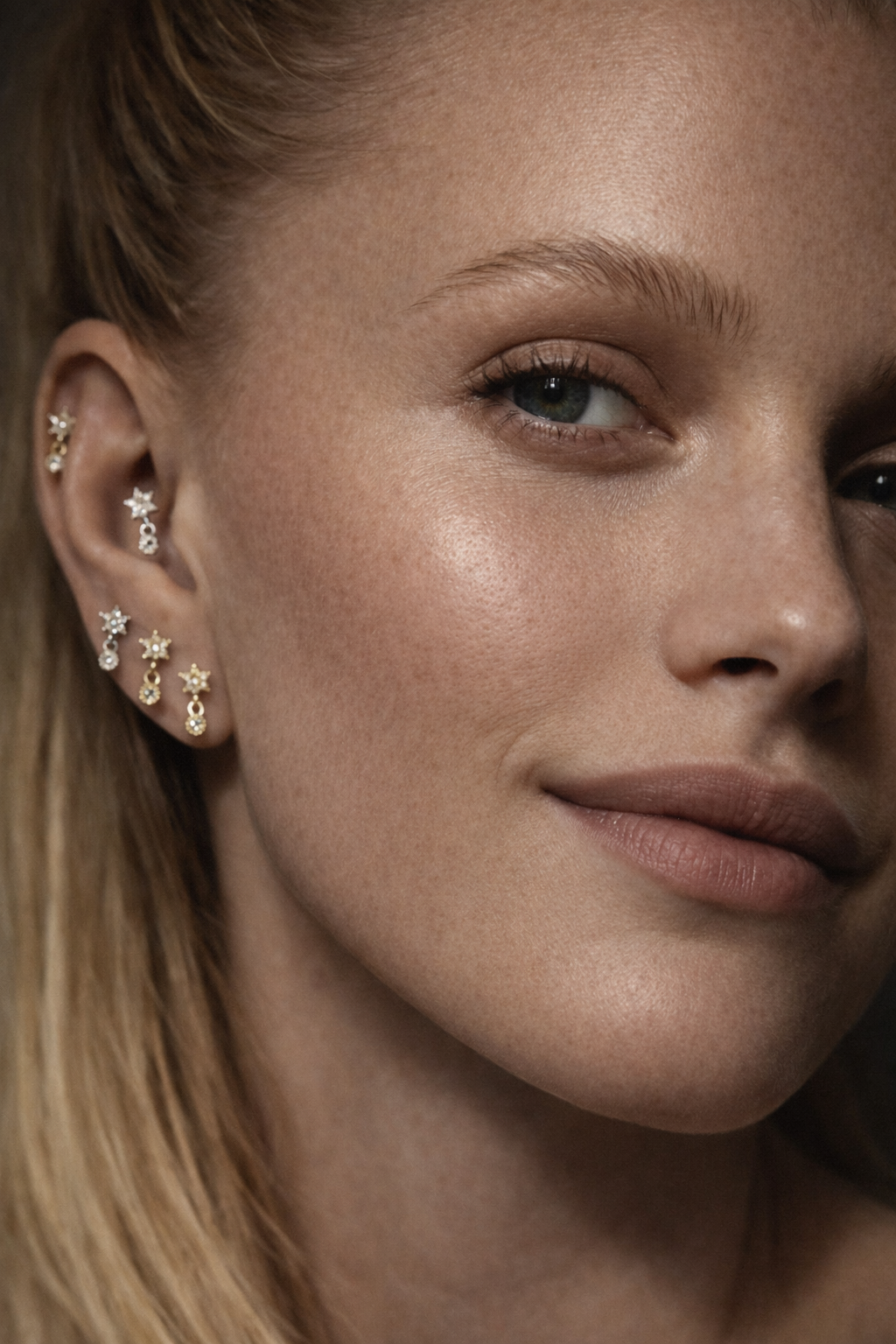 Close-up model wearing Romy Silver star drop stud in 2nd lobe piercing