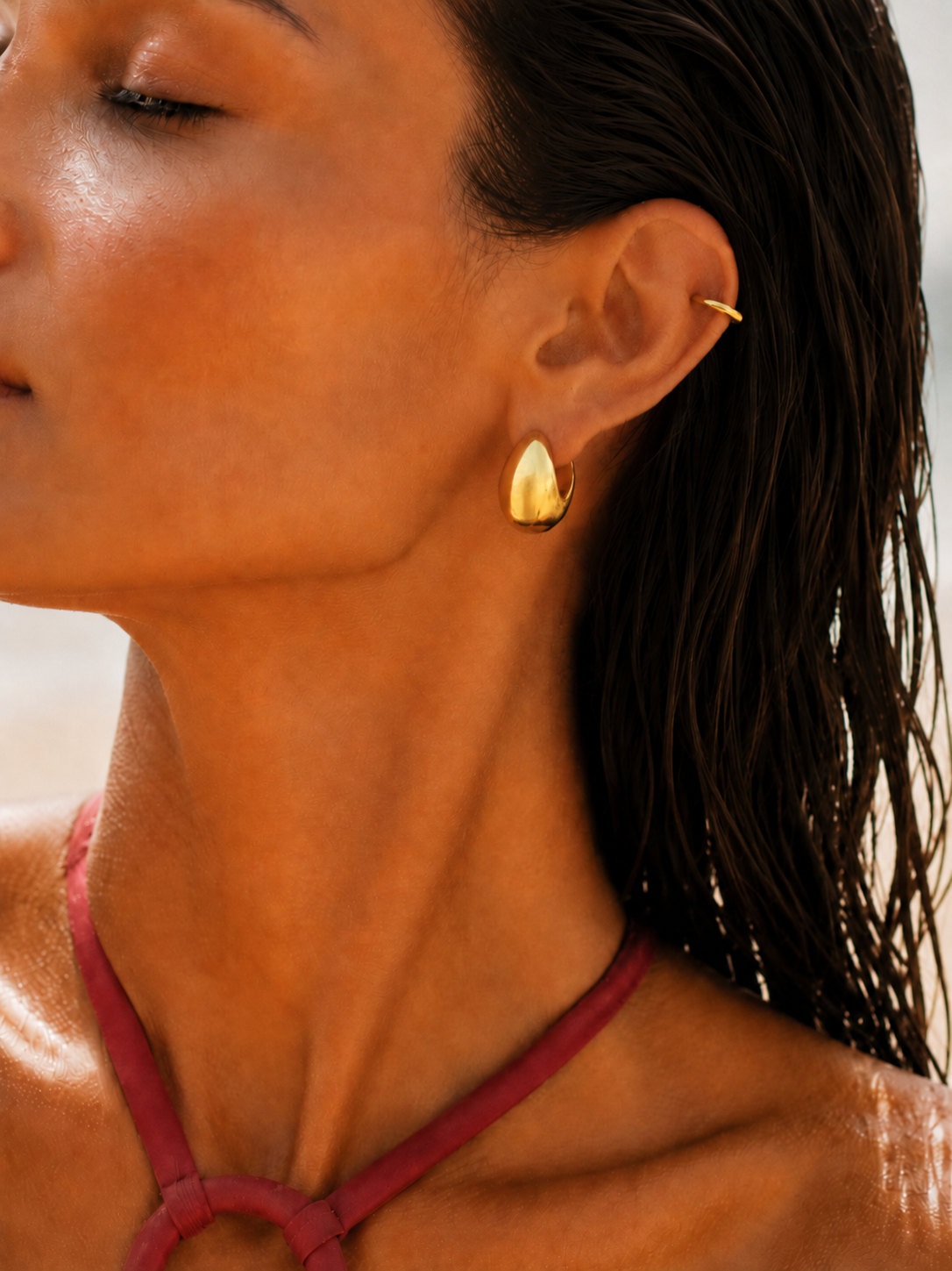 Minimal gold ear look styled by Galleria Armadoro with a sculptural Sophie hoop earring and a slim gold ear cuff.