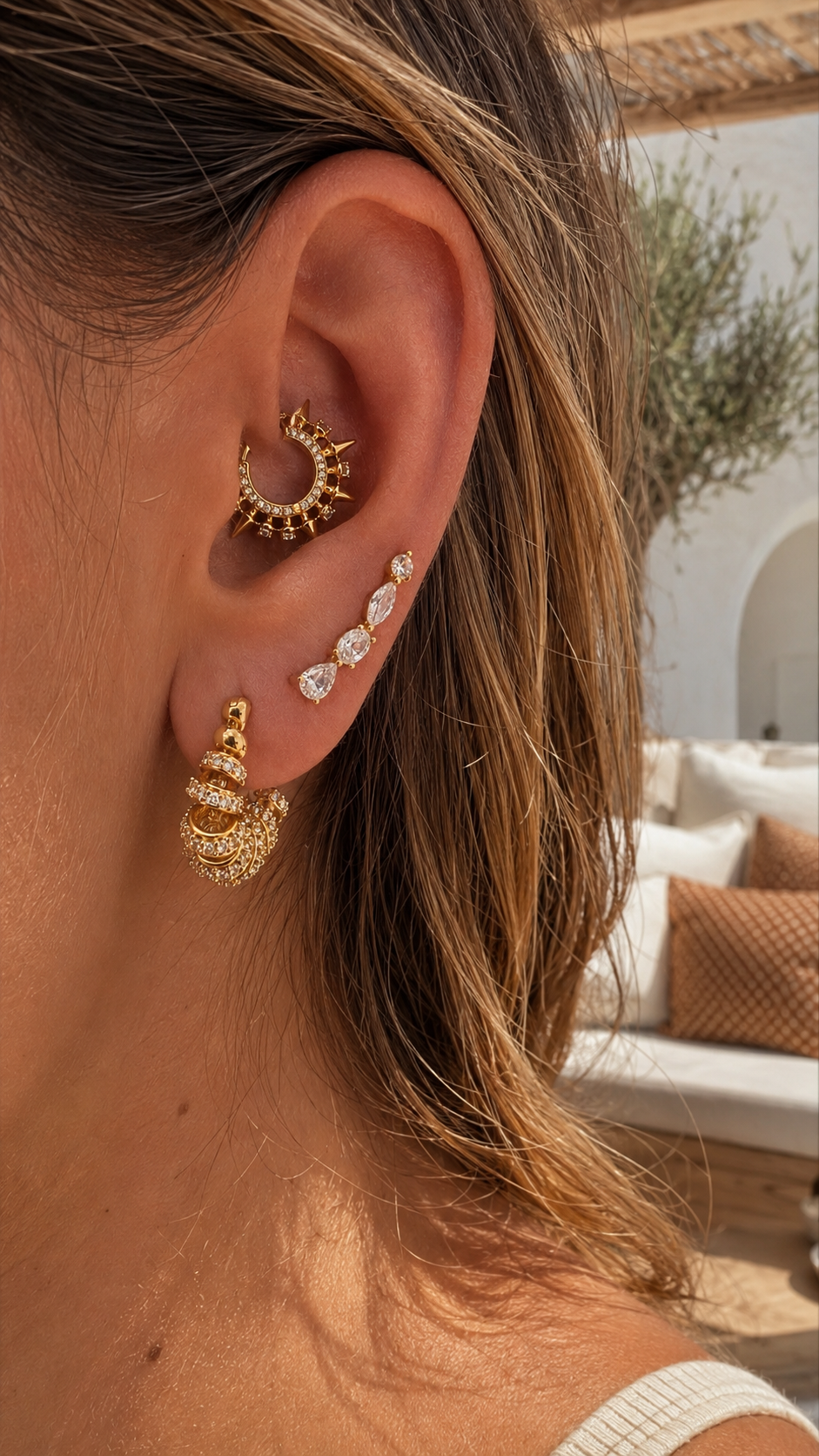 Gold daith ear stack styled by Galleria Armadoro with a sculptural Spina daith earring, marquise details and layered pavé lobe earrings.