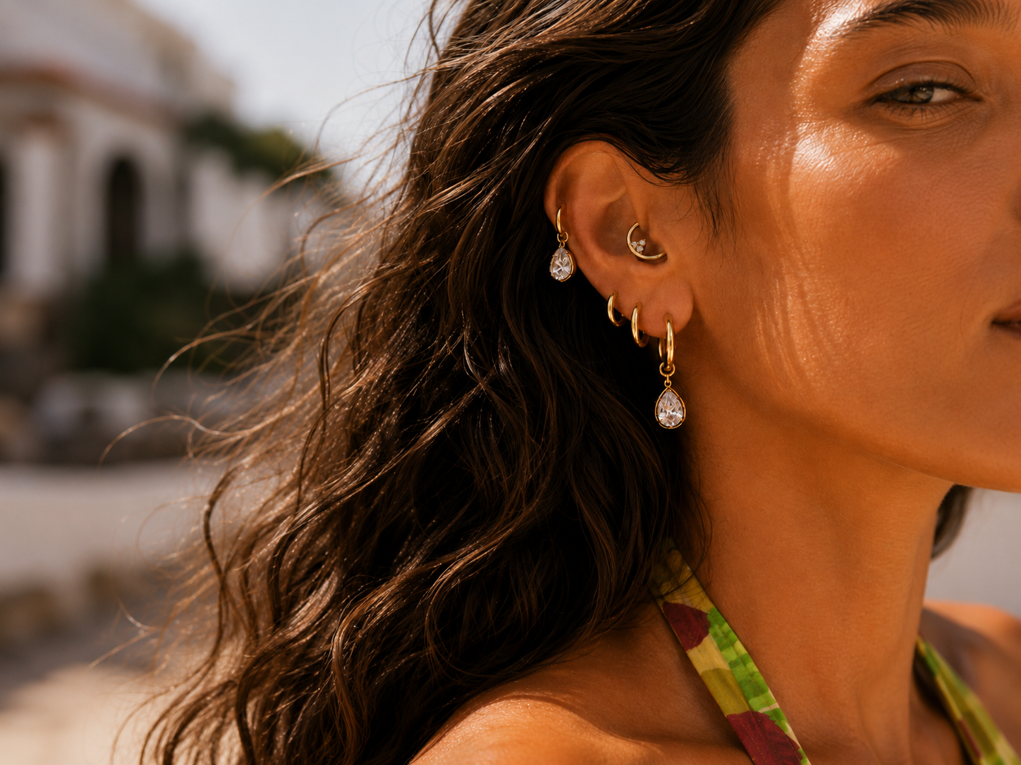 Minimal gold ear look styled by Galleria Armadoro with a sculptural Sophie hoop earring and a slim gold ear cuff.