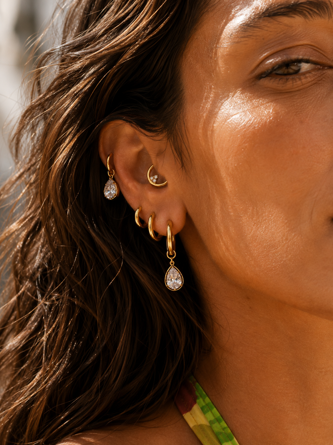Minimal gold ear look styled by Galleria Armadoro with a sculptural Sophie hoop earring and a slim gold ear cuff.
