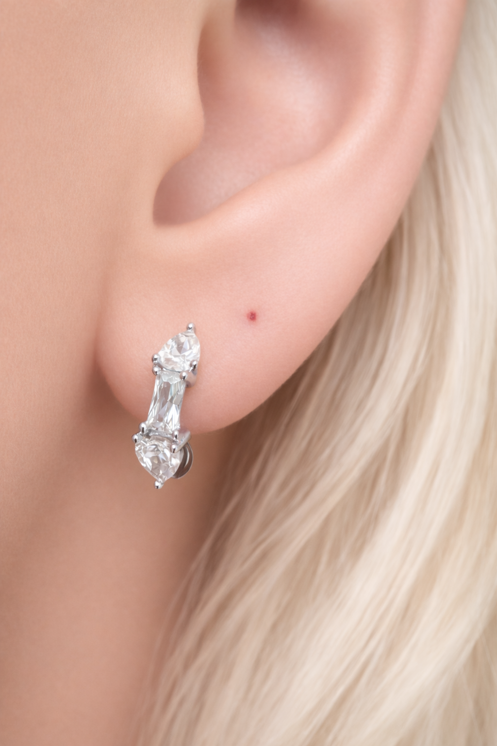 Silver huggie earring worn on ear, Ivy Mini Hoop