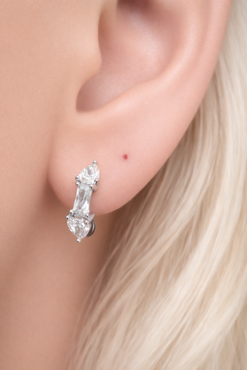 Silver huggie earring worn on ear, Ivy Mini Hoop