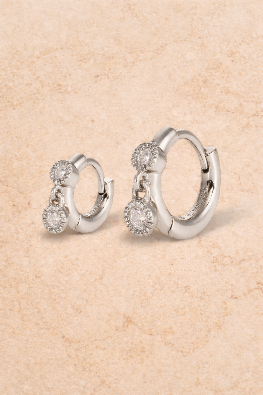 Double ear piercing sterling silver huggie set with 6.5mm and 8.5mm simple shaker hoops and white CZ stones
