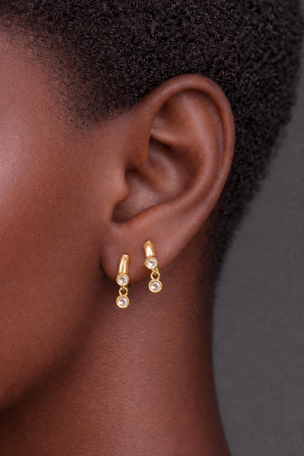Two earrings in one ear styling with simple shaker gold huggies for second ear piercings