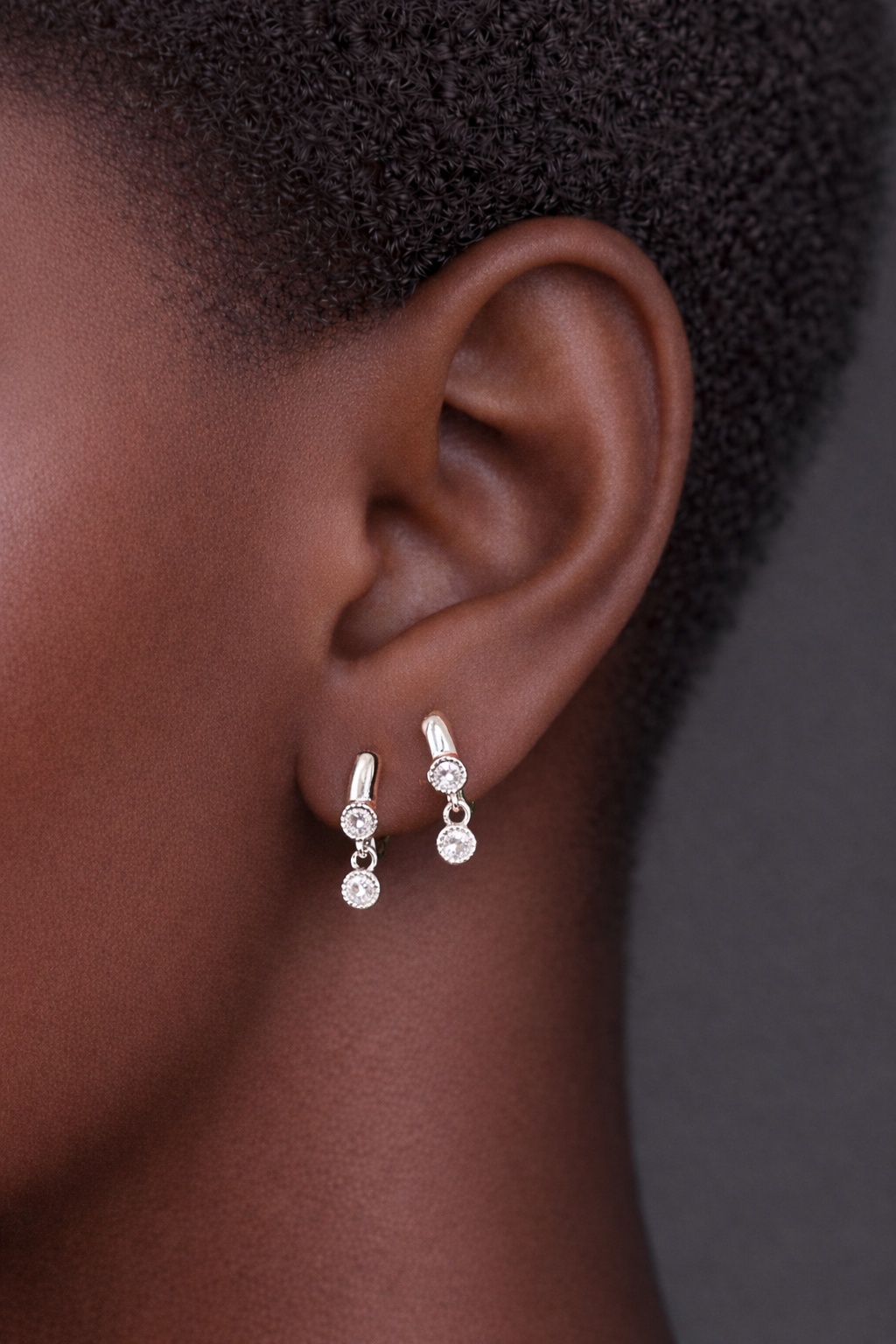 Two earrings in one ear styling with simple shaker sterling silver huggies for second ear piercings