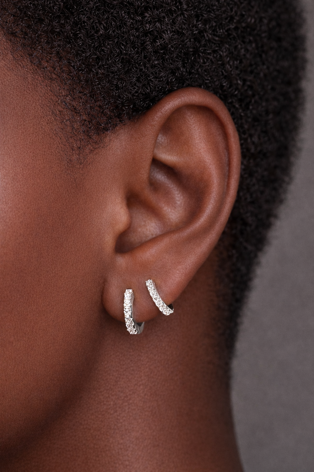 Two earrings in one ear styling with simple sterling silver pavé huggies for second ear piercings and helix