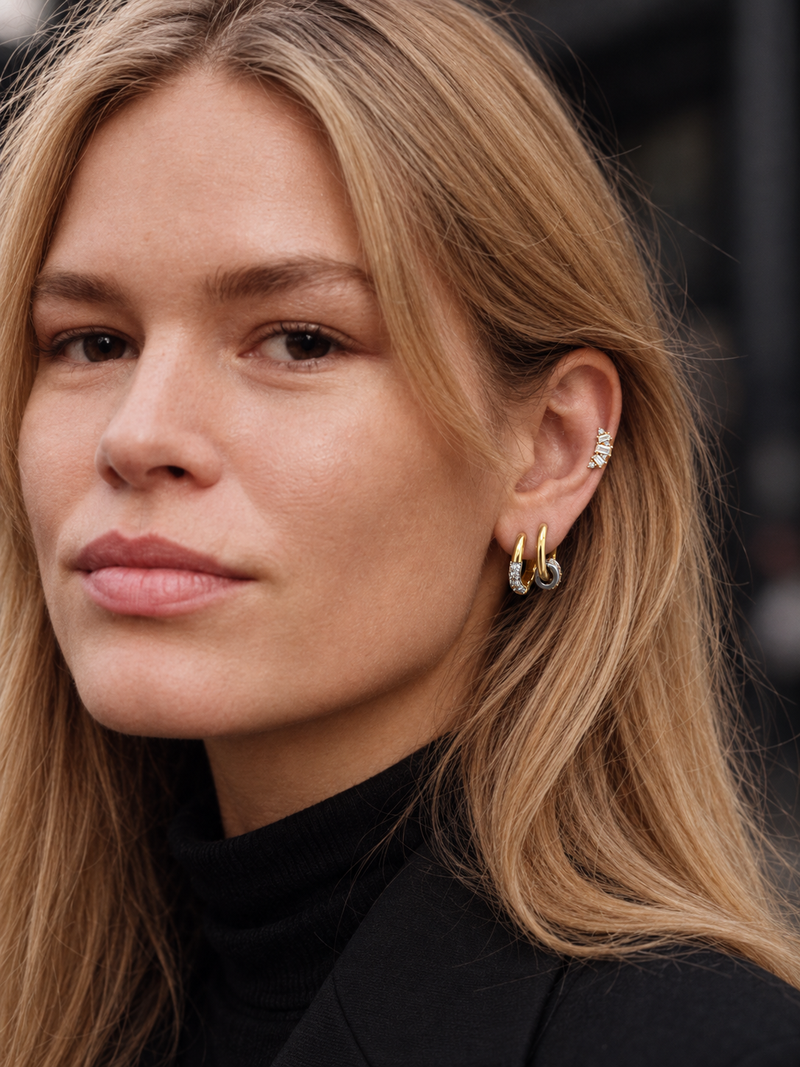 Minimal mixed-metal ear look by Galleria Armadoro featuring simple two-tone hoops and the Lumière Stud styled on the middle helix.