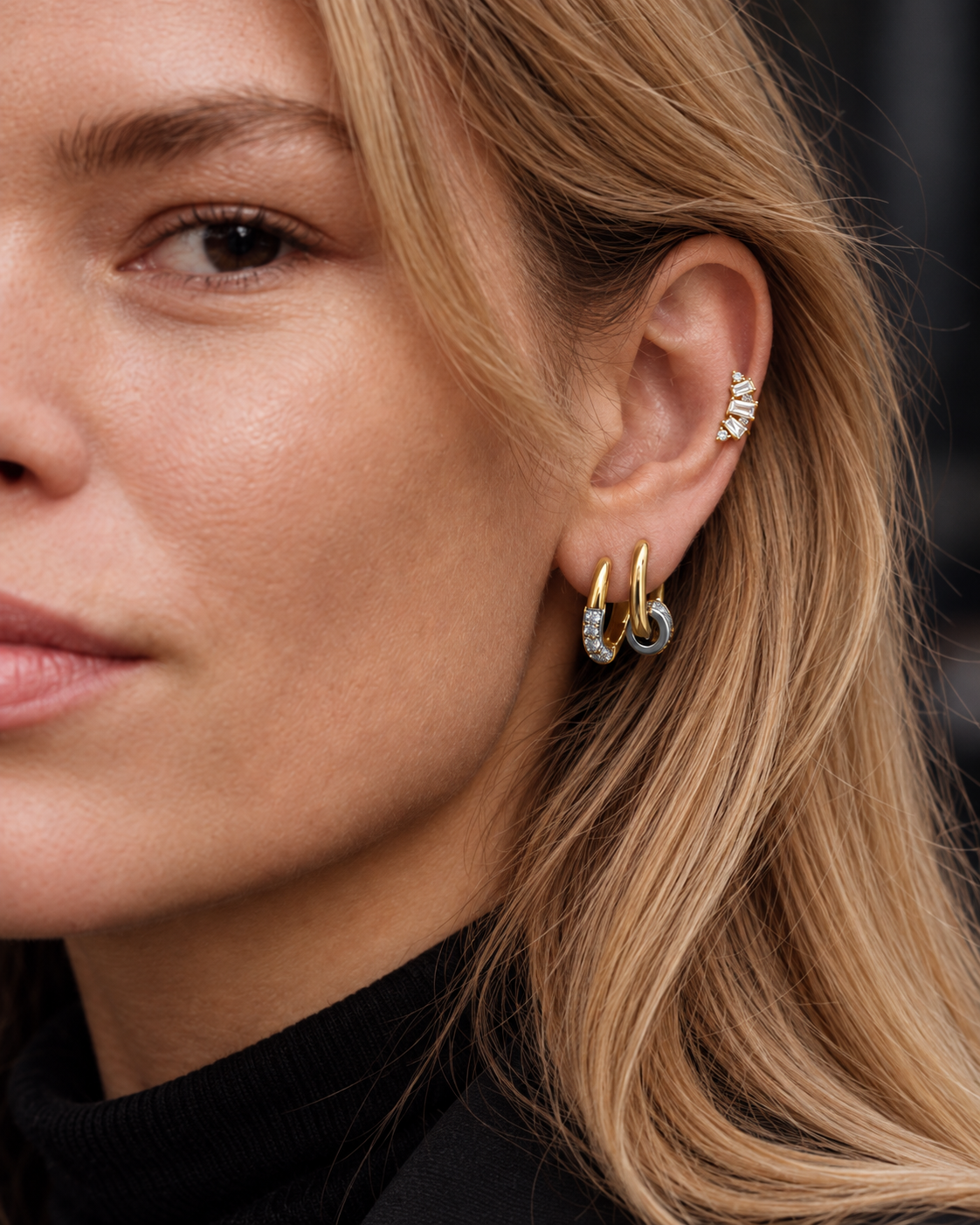 Minimal mixed-metal ear look by Galleria Armadoro featuring simple two-tone hoops and the Lumière Stud styled on the middle helix.