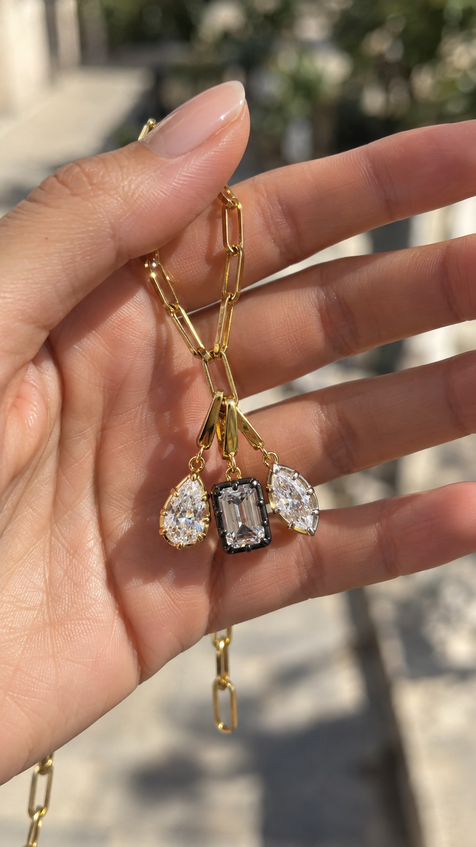 Gold paperclip chain necklace by Galleria Armadoro styled with three Vittoria charms: teardrop, emerald-cut black rhodium and marquise.