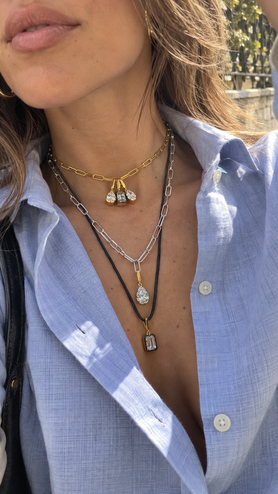 Mixed-metal layered necklace look by Galleria Armadoro featuring gold and silver link chains, a black cord necklace, and Vittoria interchangeable hook charms.