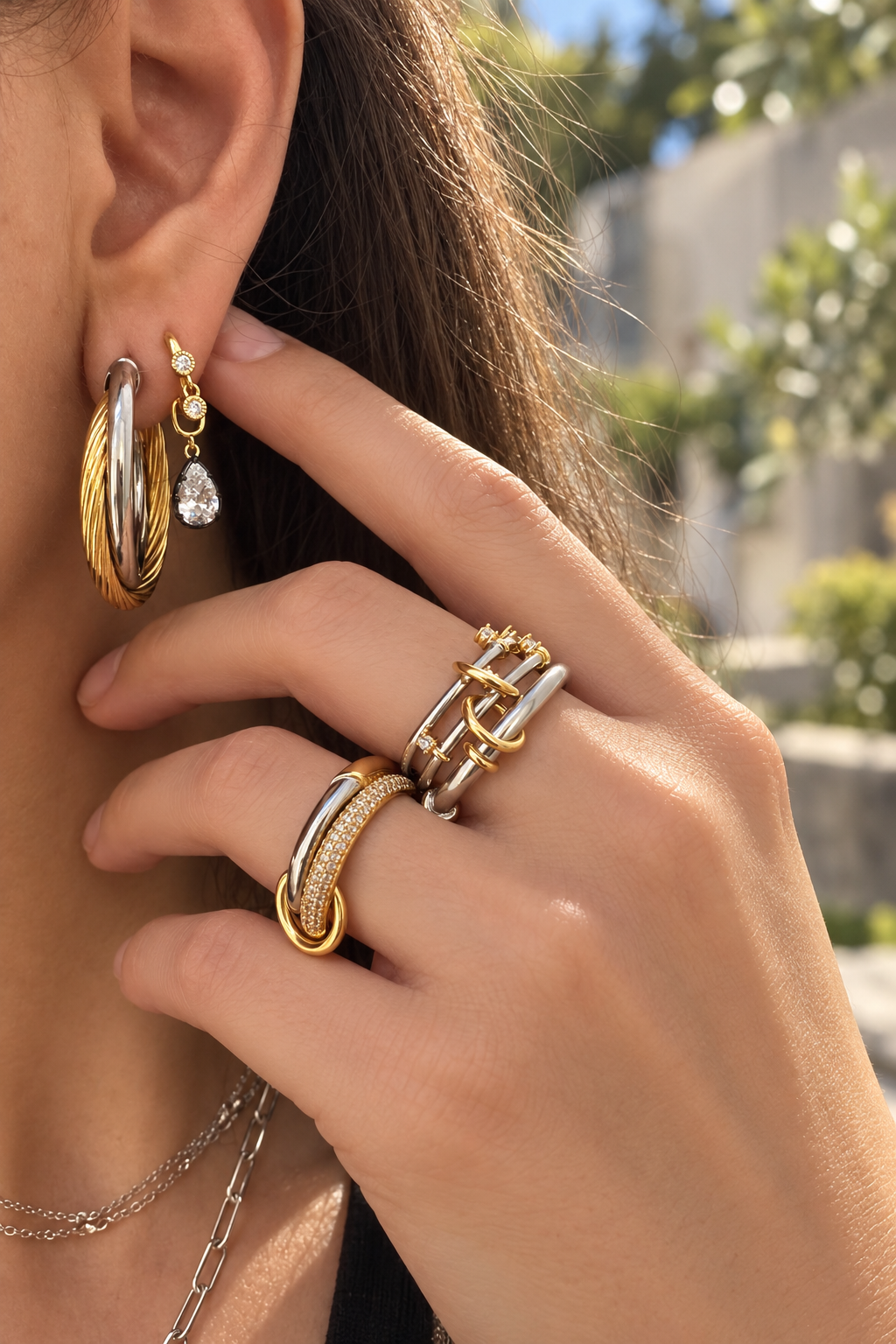 Mixed-metal jewellery look by Galleria Armadoro featuring 3 cm Allegra two-tone hoops, a Simple Shaker huggie with black rhodium teardrop charm, and mixed-metal linked rings.