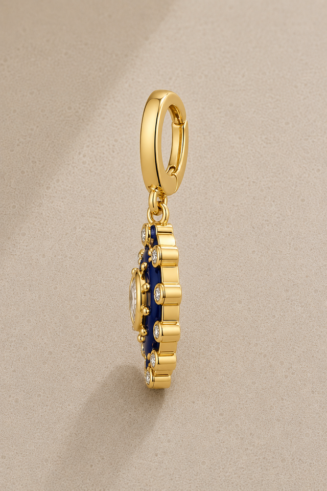 Side view of paisley evil eye gold hook charm with blue enamel and crystals