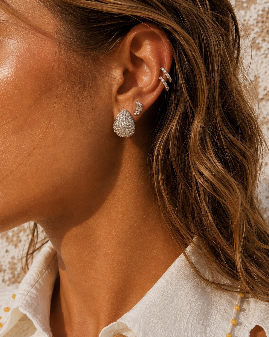 Silver ear stack by Galleria Armadoro featuring the Abbraccio Double Helix with pavé earrings, styled in warm sunlight.