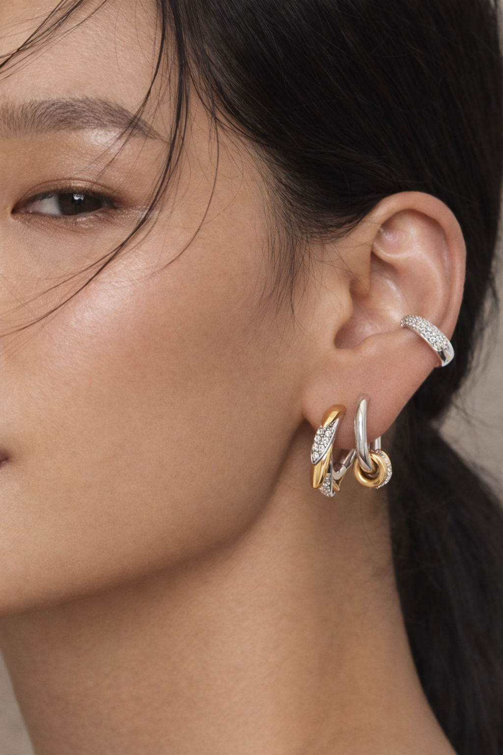 Mixed-metal ear stack by Galleria Armadoro featuring Elara earrings in gold and silver with a pavé conch cuff.