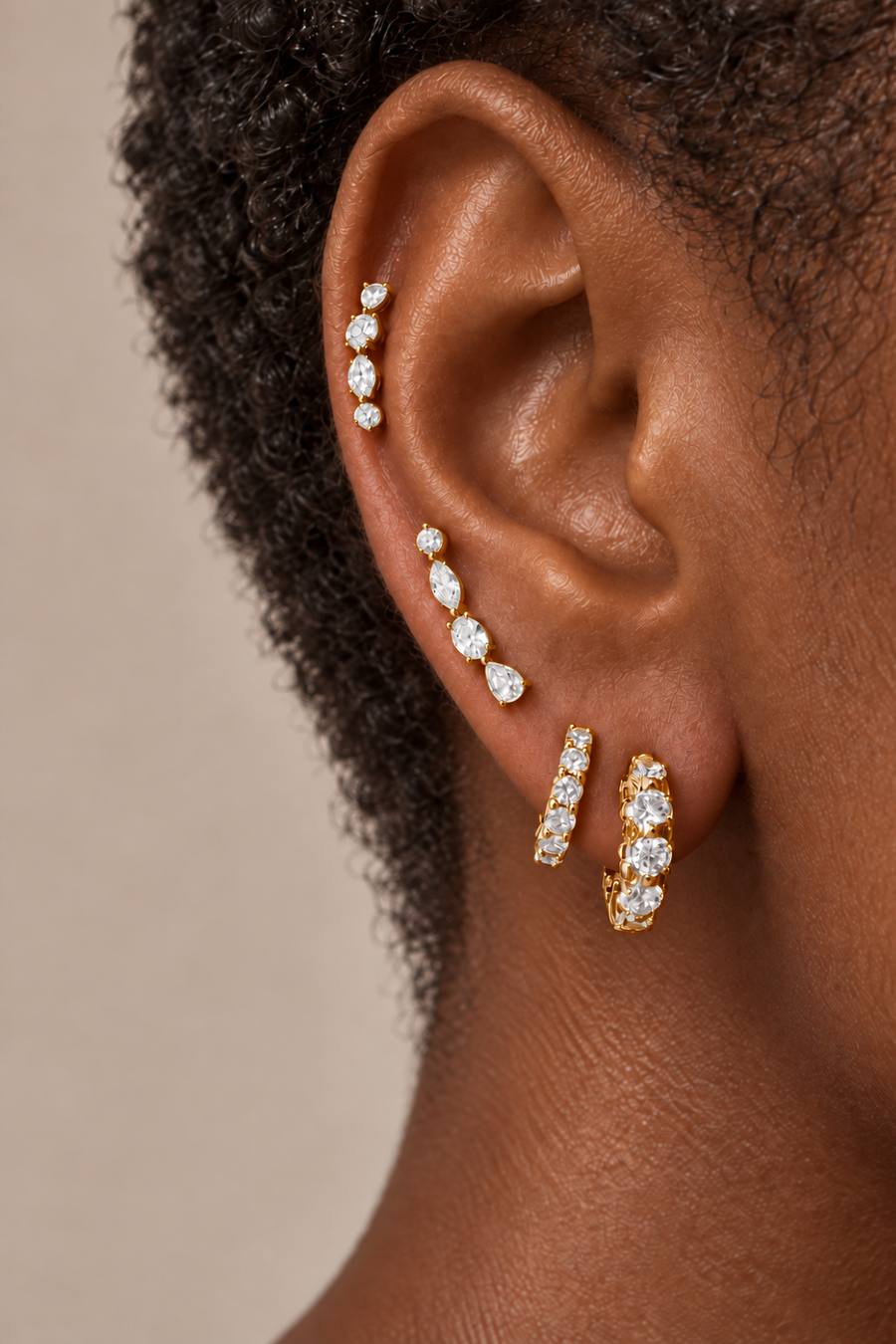 Gold ear stack by Galleria Armadoro featuring the Gatsby earring at the lobe with two Riviera pieces styled higher up the ear.