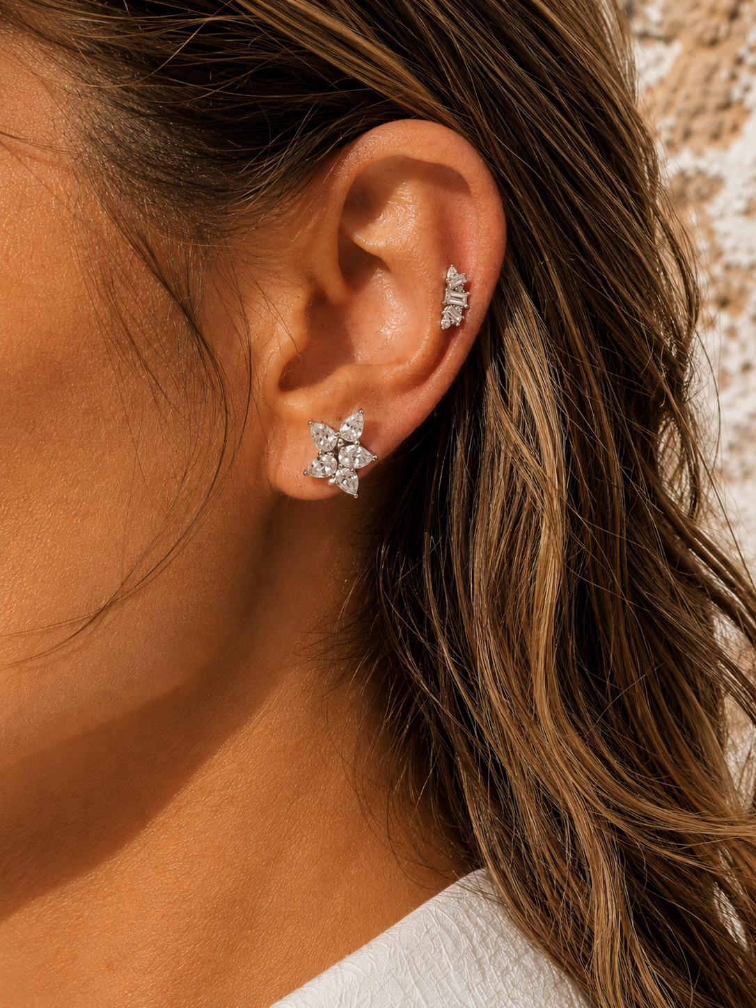 Silver ear stack by Galleria Armadoro featuring Odette and Lumière, styled in warm sunlight.