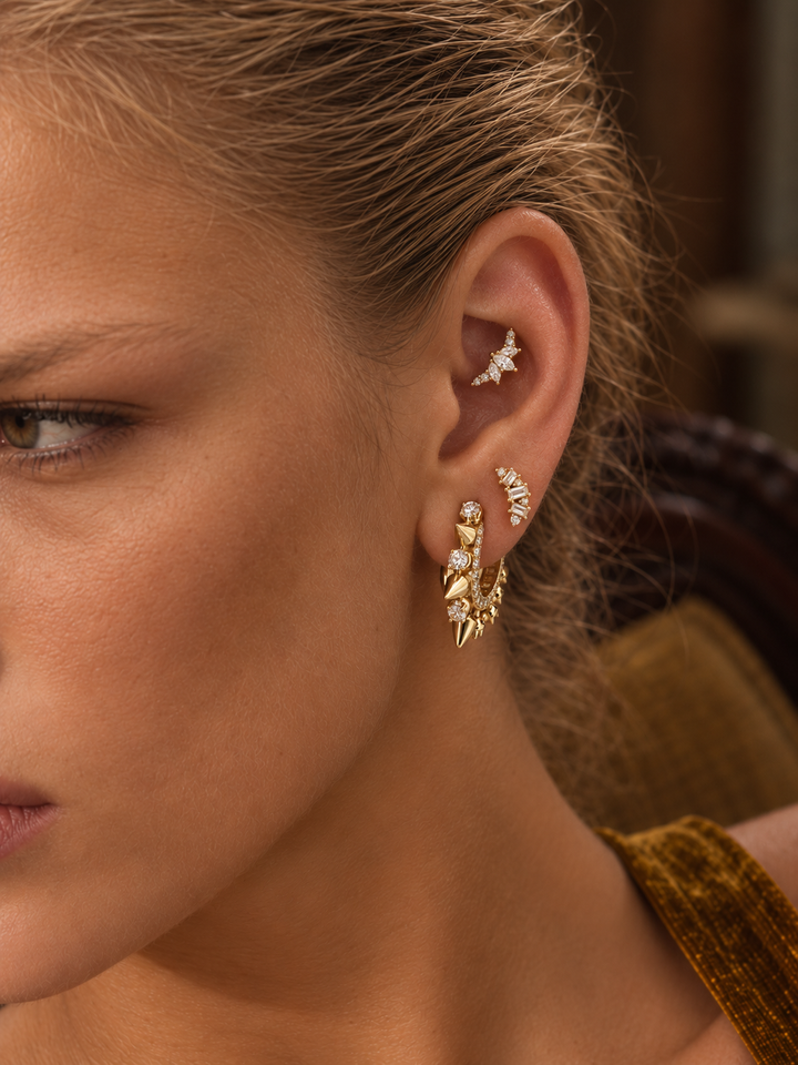 Sculptural gold ear stack by Galleria Armadoro featuring Spina with pointed gold, pavé and crystal piercing jewellery.