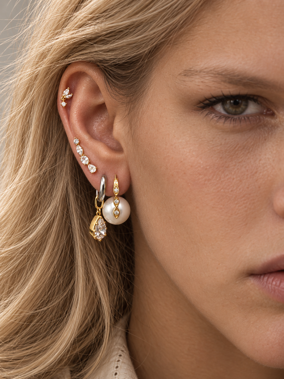 Pearl and mixed-metal ear stack by Galleria Armadoro featuring the Tasha Pearl earring and 8.5mm Vittoria Silver & Gold Teardrop Charm Huggie with crystal details.