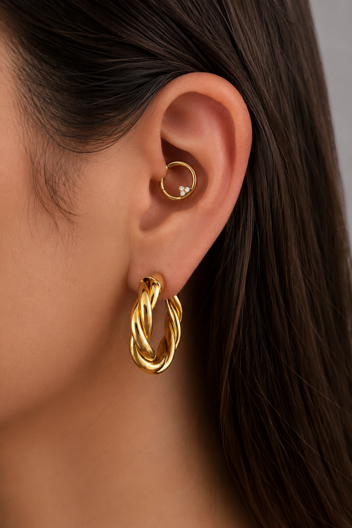 Gold ear story by Galleria Armadoro featuring 3 cm Tina Hoops with the Trinity Daith Clicker.