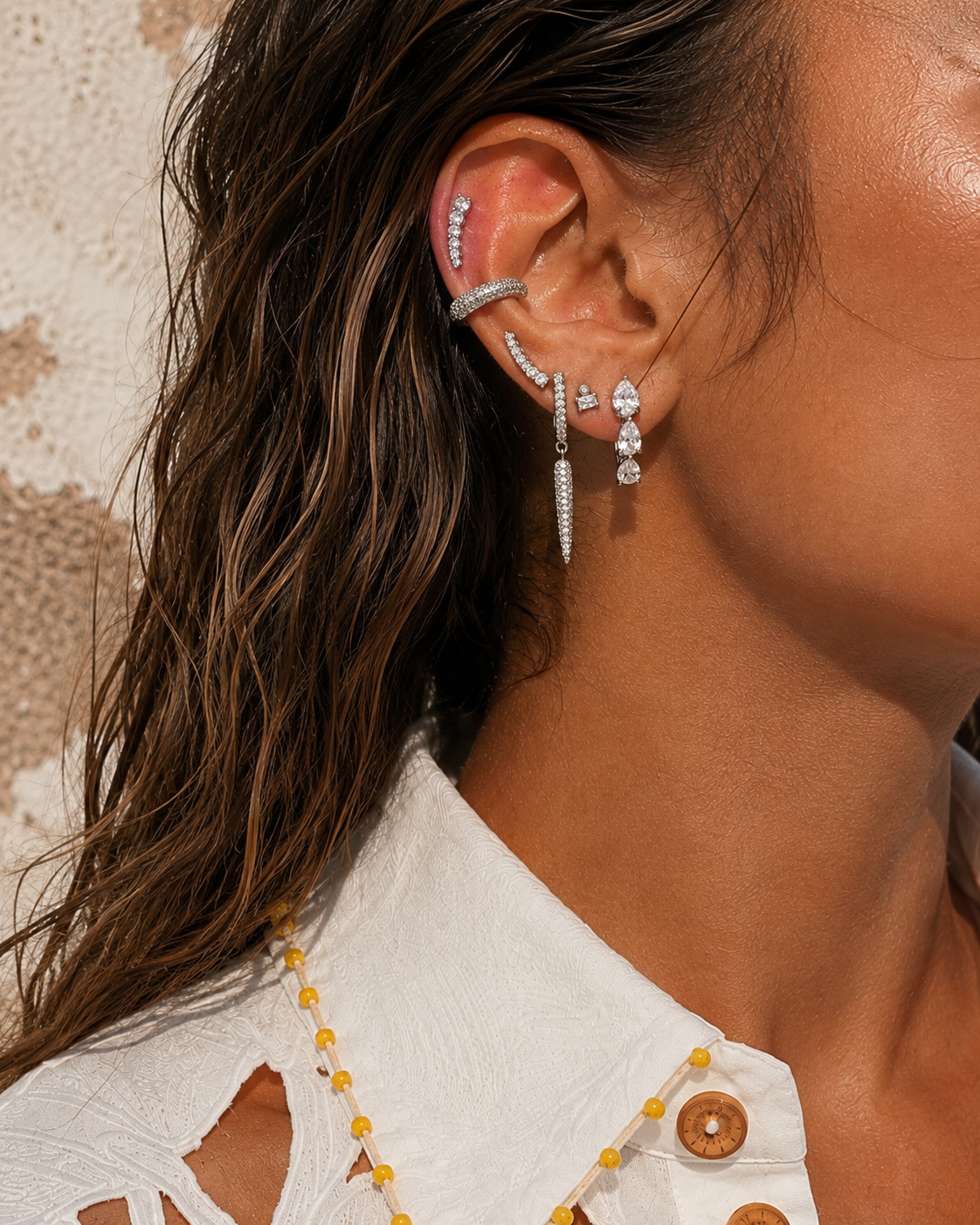 Maximalist silver ear stack by Galleria Armadoro featuring pavé earrings, marquise drops, ear cuffs and layered piercing jewellery.