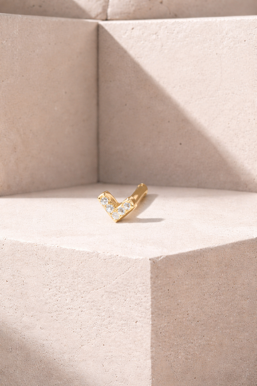 V-shaped gold vermeil stud worn on helix piercing with secure ball screw fastening