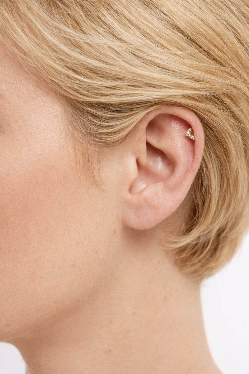 V-shaped gold vermeil stud worn on helix piercing with secure ball screw fastening
