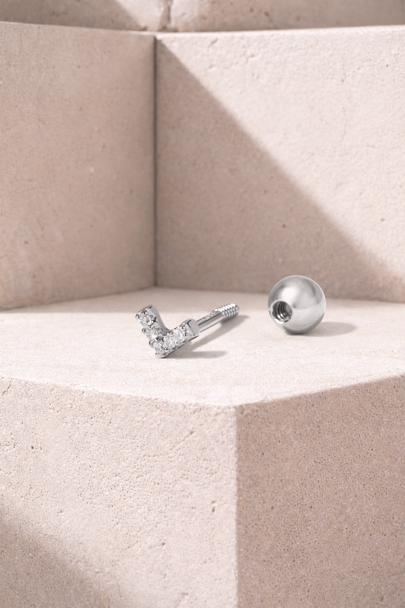 V-shaped silver stud earring shown unscrewed with threaded post and hollow ball screw backing