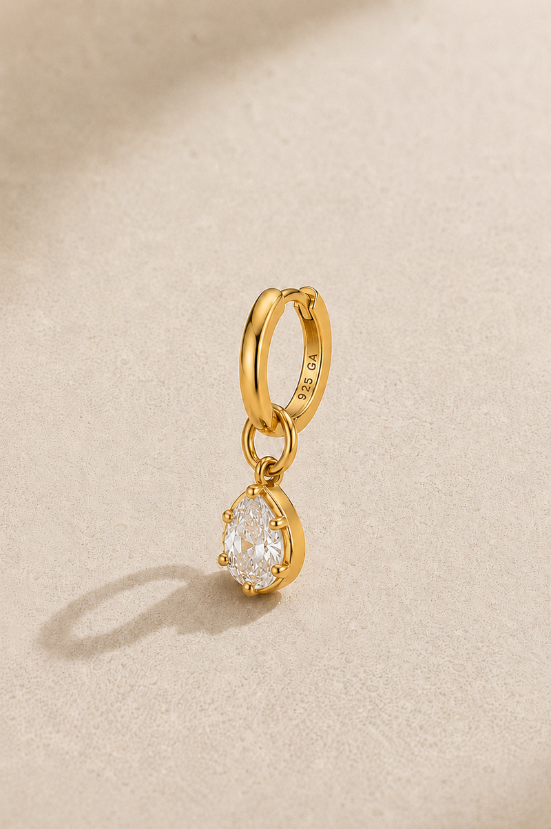 Shop the 6.5mm gold huggie earring set with Vittoria gold charm. 925 sterling silver, 24ct gold plating, hypoallergenic and perfect for cartilage and upper lobe piercings.
