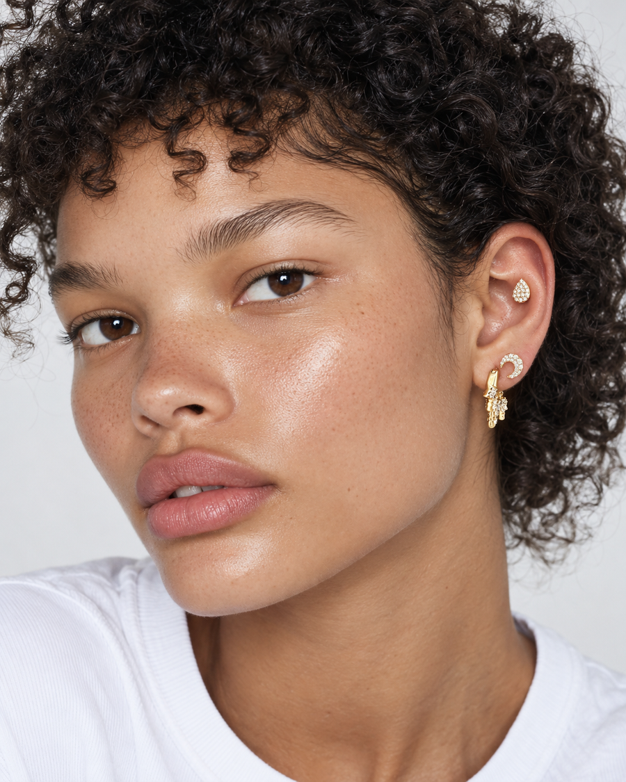 Ear stack by Galleria Armadoro featuring the Ziggy huggie, a star stud and a teardrop stud styled inside the conch.