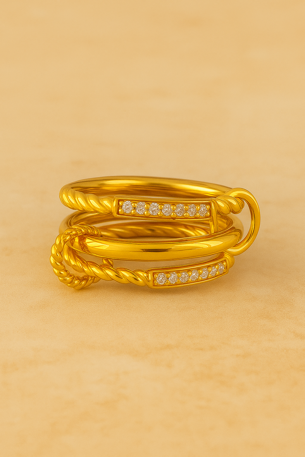 Multiple gold sculptural rings styled on hand, including Carmella Speira.