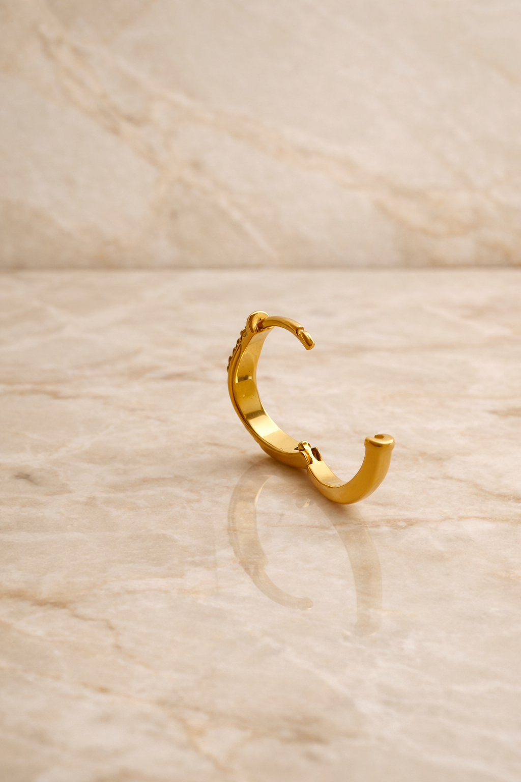 Back view of Amara Kyma two tone huggie earring showing hinged closure