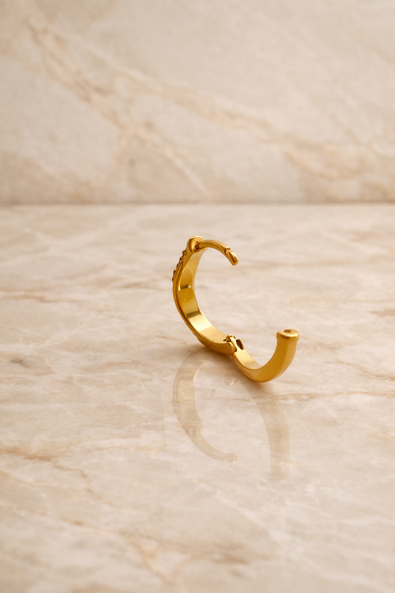 Back view of Amara Kyma two tone huggie earring showing hinged closure