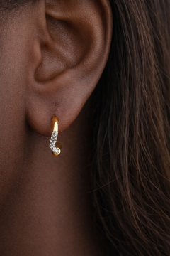 Amara Kyma mixed metal huggie earring worn in first lobe piercing on model